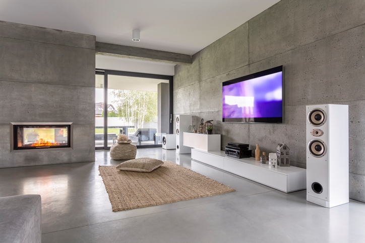 Tv living room with window, fireplace and concrete wall effect